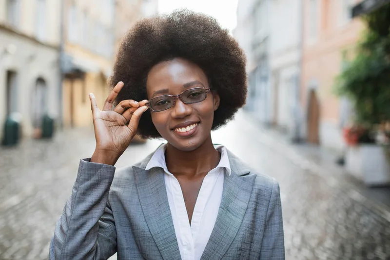 Young business professional smiling on a city street