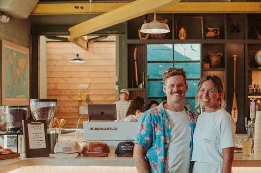 Young couple running their independent coffee shop